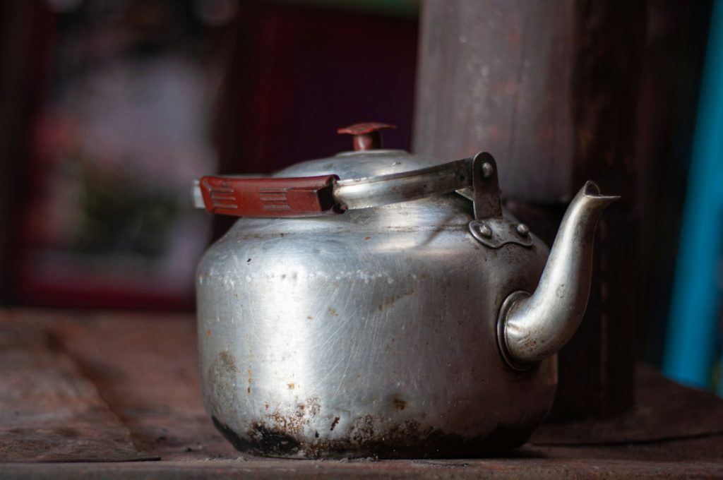 Metal kettle with overhead handle
